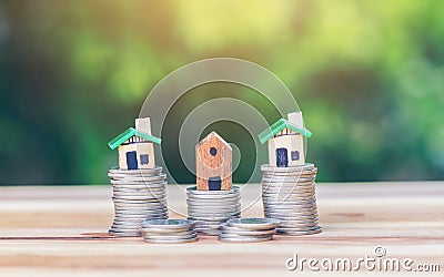 The house placed on a coin is like a village or condo. Stock Photo