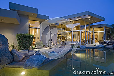 House With Pool In Backyard At Dusk Stock Photo