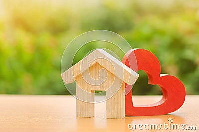 House with a red wooden heart. House of lovers. Parental hospitable home. Housing construction of your dreams. Buying and renting Stock Photo