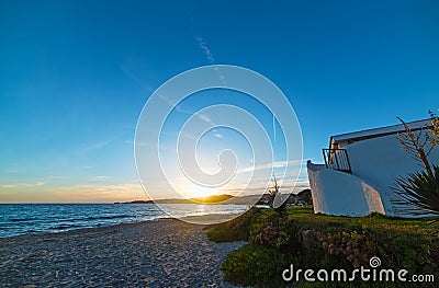 House by the sea at sunset Stock Photo