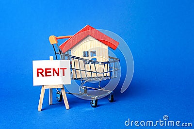 A house in a shopping cart and an easel with a word Rent. Rental housing and apartments, choice between buying and renting Stock Photo