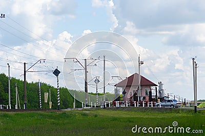 House of signalman on the cross of railway and car road Stock Photo