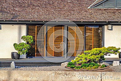 House with sliding glass doors with deck and garden view in Huntington Beach Stock Photo