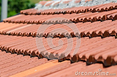 House with sloping pitched roof, self-supporting red tiles. Stock Photo