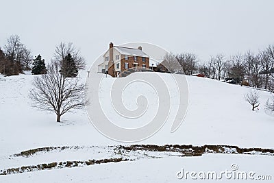 House on a snow covered hill, in a rural area of Carroll County, Maryland. Stock Photo