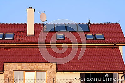 House with solar panels on the roof for water heating Stock Photo