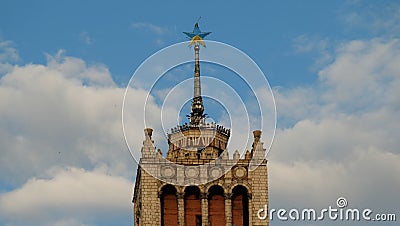 A house with a spire on which the star is painted in yellow and blue against the background of the sky. Stock Photo