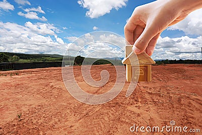 House symbol with location pin and Empty dry cracked swamp reclamation soil Stock Photo
