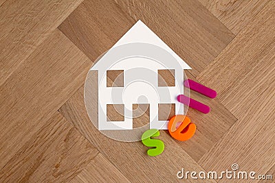 House symbol on wooden floor sell lettering Stock Photo