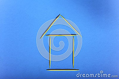 House of toothpicks on a blue background, concept of affordable housing Stock Photo