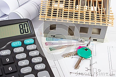 House under construction, keys, calculator, polish currency and electrical drawings, concept of building home Stock Photo