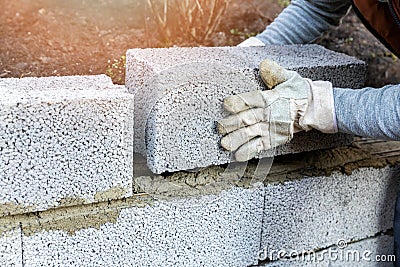 House wall construction - mason laying expanded clay blocks Stock Photo