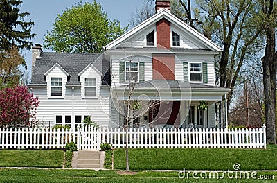 House with White Picket Fence Stock Photo