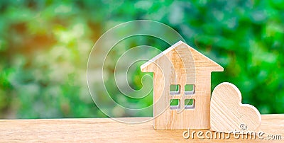 House with a wooden heart. House of lovers. Affordable housing for young families. Valentine`s day house. Stock Photo