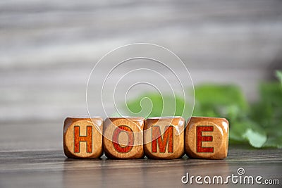 House. The word home is written on wooden cubes. Inscription on wood dies Stock Photo