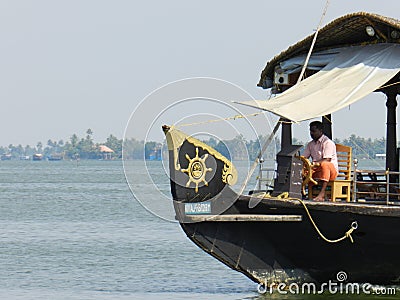 Houseboat captain making headway in backwater near Alleppey, Kerala, India Editorial Stock Photo