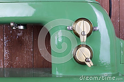 Household appliances - Front view Fragment retro green sewing machine wooden background Stock Photo