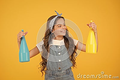 Household duties. Girl cute kid cleaning around. Protect sensitive skin. Kid cleaning at home. On guard of cleanliness Stock Photo