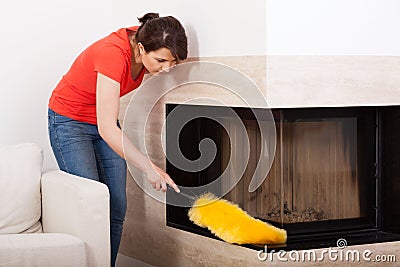 Housekeeper during dusting Stock Photo