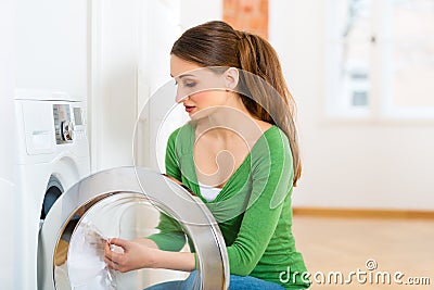 Housekeeper with washing machine Stock Photo