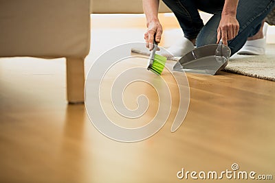 Person using brush and dustpan Stock Photo