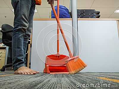 A Housekeeping Sweeping The Carpet Office Floor Stock Photo