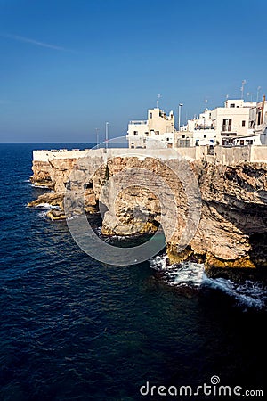 Houses on dramatic cliffs over Adriatic sea in Polignano a Mare, Italy, sunny day Stock Photo