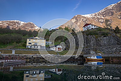 houses in flam an a small boat with water reflection Editorial Stock Photo