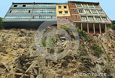 Houses hanging over the cliffs. Traditional georgian architecture. Stock Photo