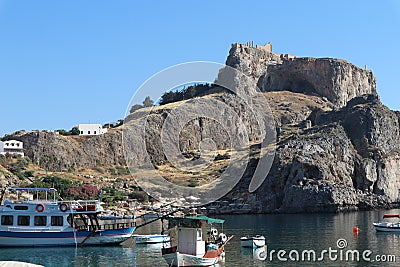 Houses on the Hill Boats with Small Row Boat, Still Waters and Cliffs Editorial Stock Photo