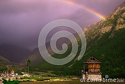 Houses in a mountain village with a rainbow background Stock Photo