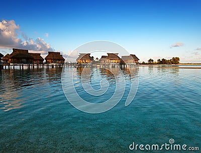 Houses on piles on water at the time sunset. Stock Photo