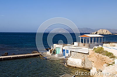 Houses rock cliffs Mediterranean Sea Milos Stock Photo