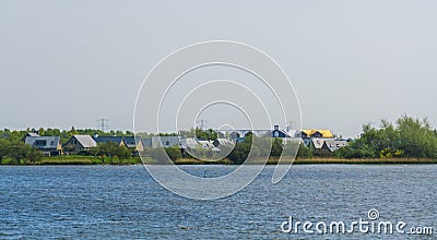 Houses at the seaside of Tholen, Bergse diepsluis, Oesterdam, Zeeland, The netherlands Stock Photo