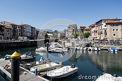 Houses and small parked boats in the port town of Llanes in Spain Editorial Stock Photo