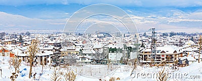 Houses with snow roofs panorama in bulgarian ski resort Bansko Stock Photo