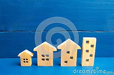 Houses stand in a row from simple to large. Concept of urbanization and population density. The growth of cities, the construction Stock Photo