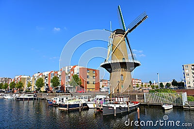 Houses and windmill along river Nieuwe Maas at Delfshaven Editorial Stock Photo