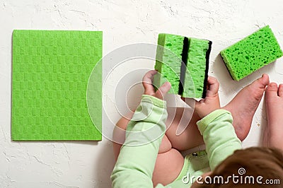 Housewife and children picking up toys after playing at home Stock Photo