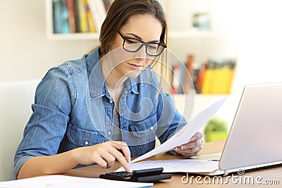 Housewife doing accounting calculating expenses at home Stock Photo