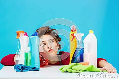 Housewife looks tired and deep in thoughts while cleaning and washing Stock Photo