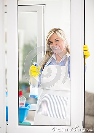 Housewife with pleasure look at shiny windows Stock Photo
