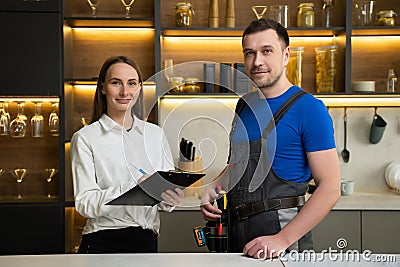 Housewife signs form to use services of professional foreman Stock Photo