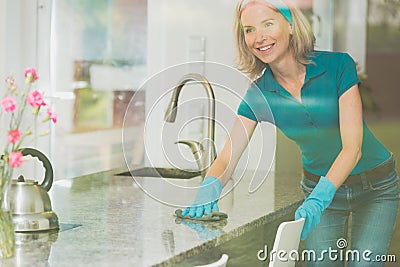 Housewife wipes counter top Stock Photo