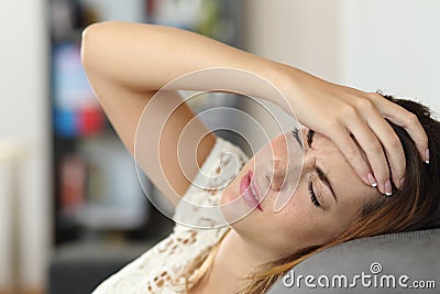 Housewife woman in a couch with headache Stock Photo