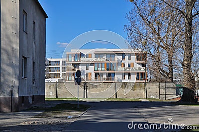 A housing estate of modern apartment blocks with balconies behind a concrete fence Editorial Stock Photo