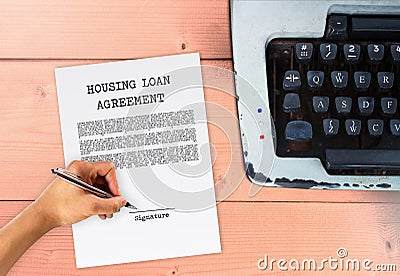 Housing loan agreement with hand signing signature Stock Photo