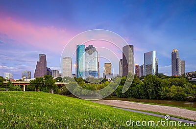 Houston Texas skyline at sunset twilight from park lawn Stock Photo