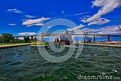 Houtmanngracht freighter from Amsterdam passes through the soo locks near a tourist boat Editorial Stock Photo