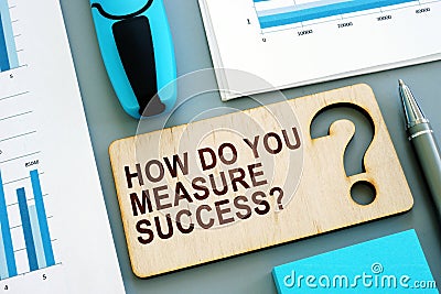 How do you measure success written sign and business report. Stock Photo